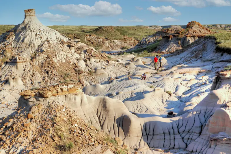Dramatic hoodoo rock formations in the Canadian Badlands under blue sky
